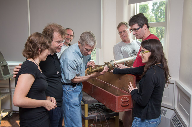 Inspecting one of the brass telescopes