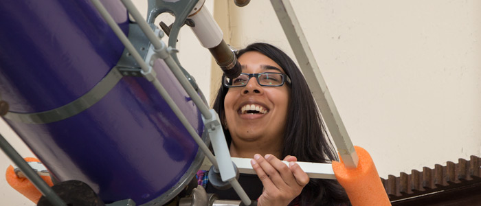 Dilini Subasingh aims the telescope at the moon.