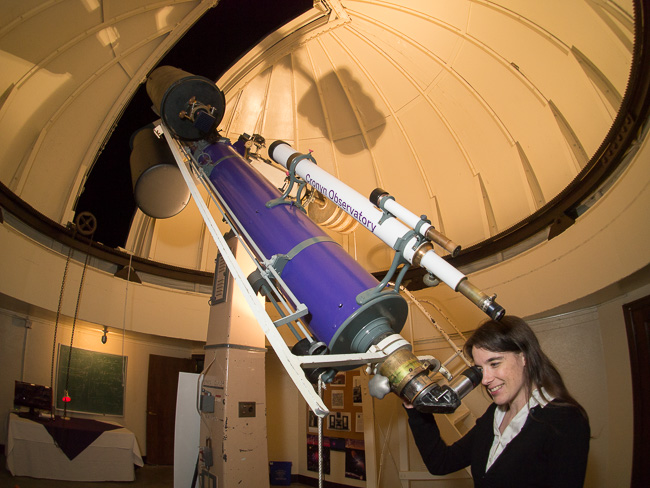 Emily McCullough at the newly painted telescopes. (photo by Dale Armstrong)