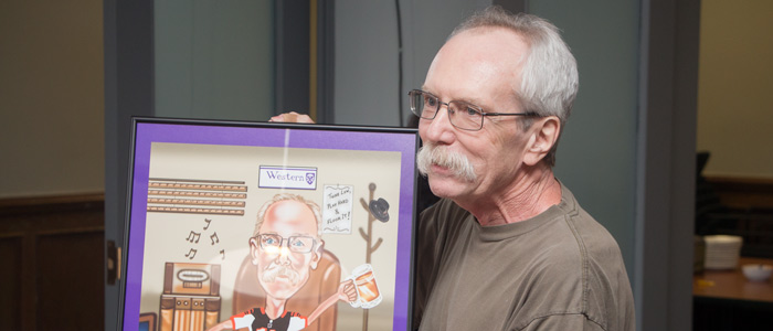 Doug receiving his caricature painting.